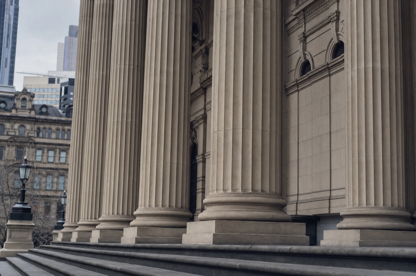 The Supreme Court of Victoria building exterior with classical columns in Melbourne on an overcast day