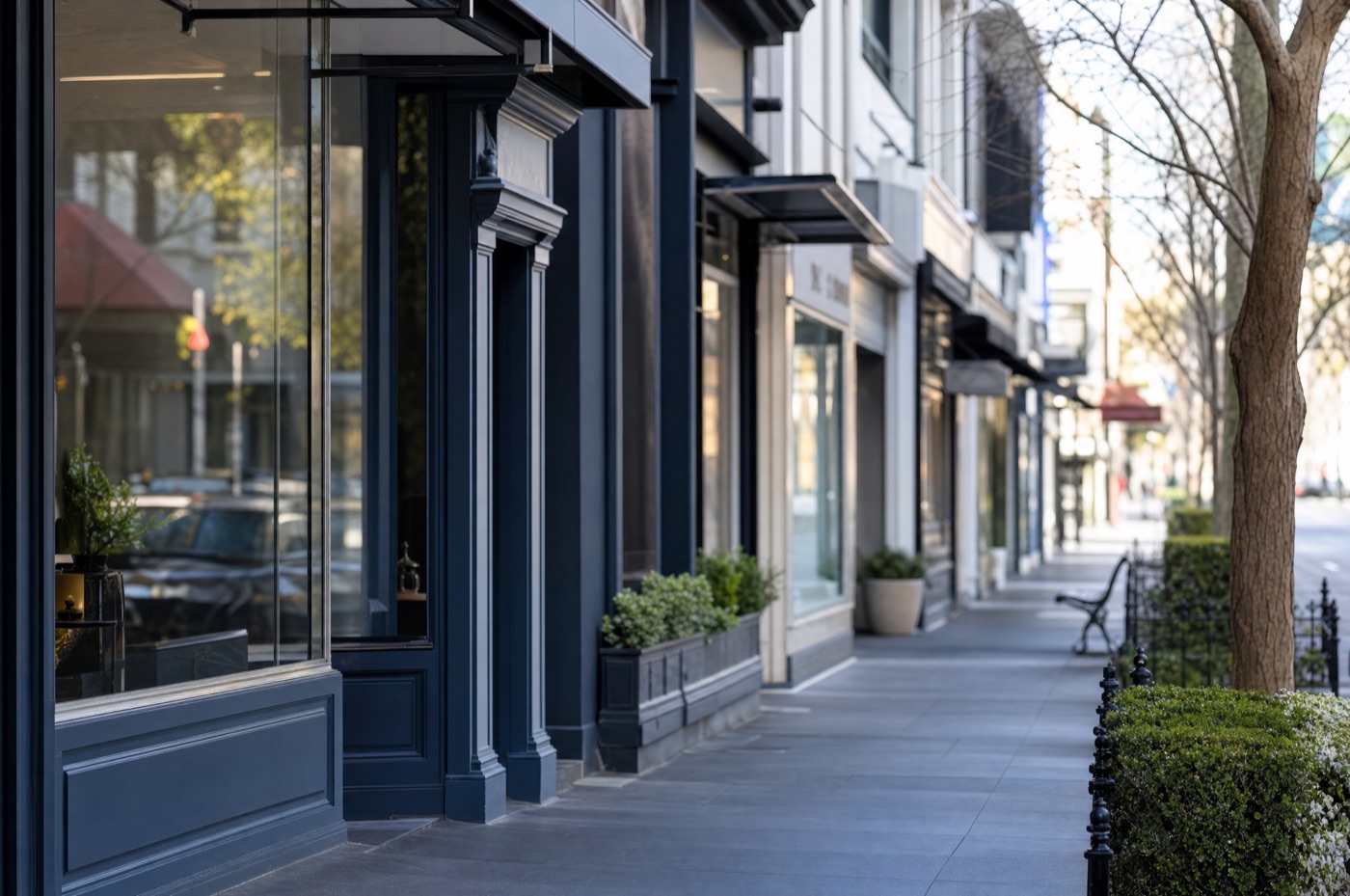 A bright Melbourne retail shopping strip with storefronts at early morning