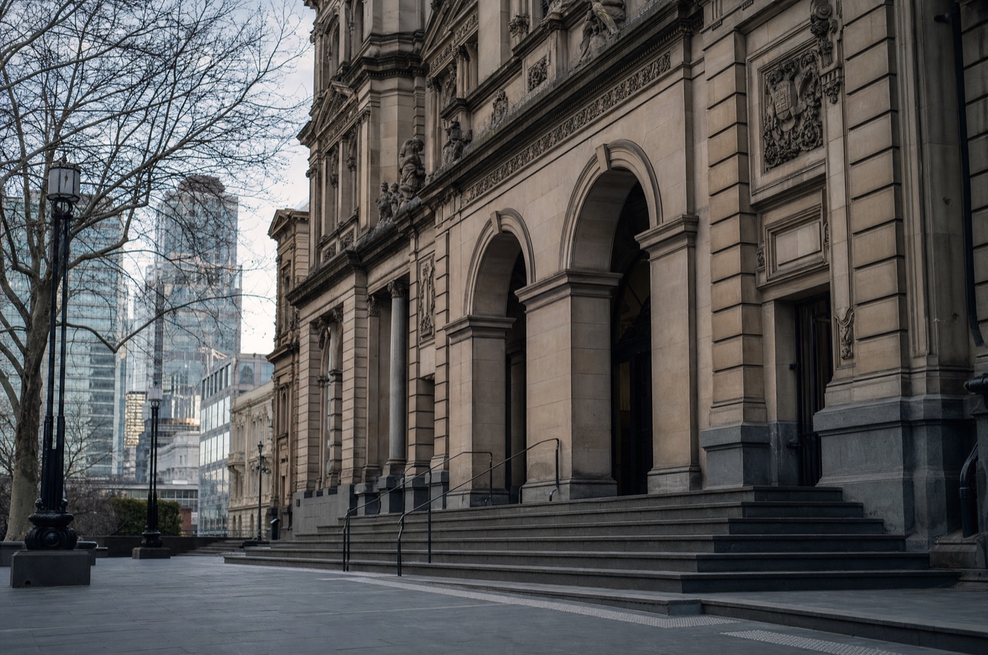 The historic Melbourne Magistrates' Court sandstone facade and entrance steps on an overcast afternoon