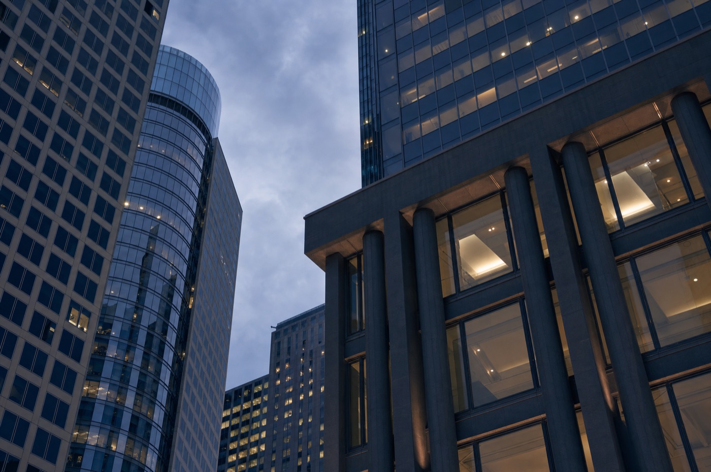 Melbourne financial-district office towers viewed from street level looking upward at dusk