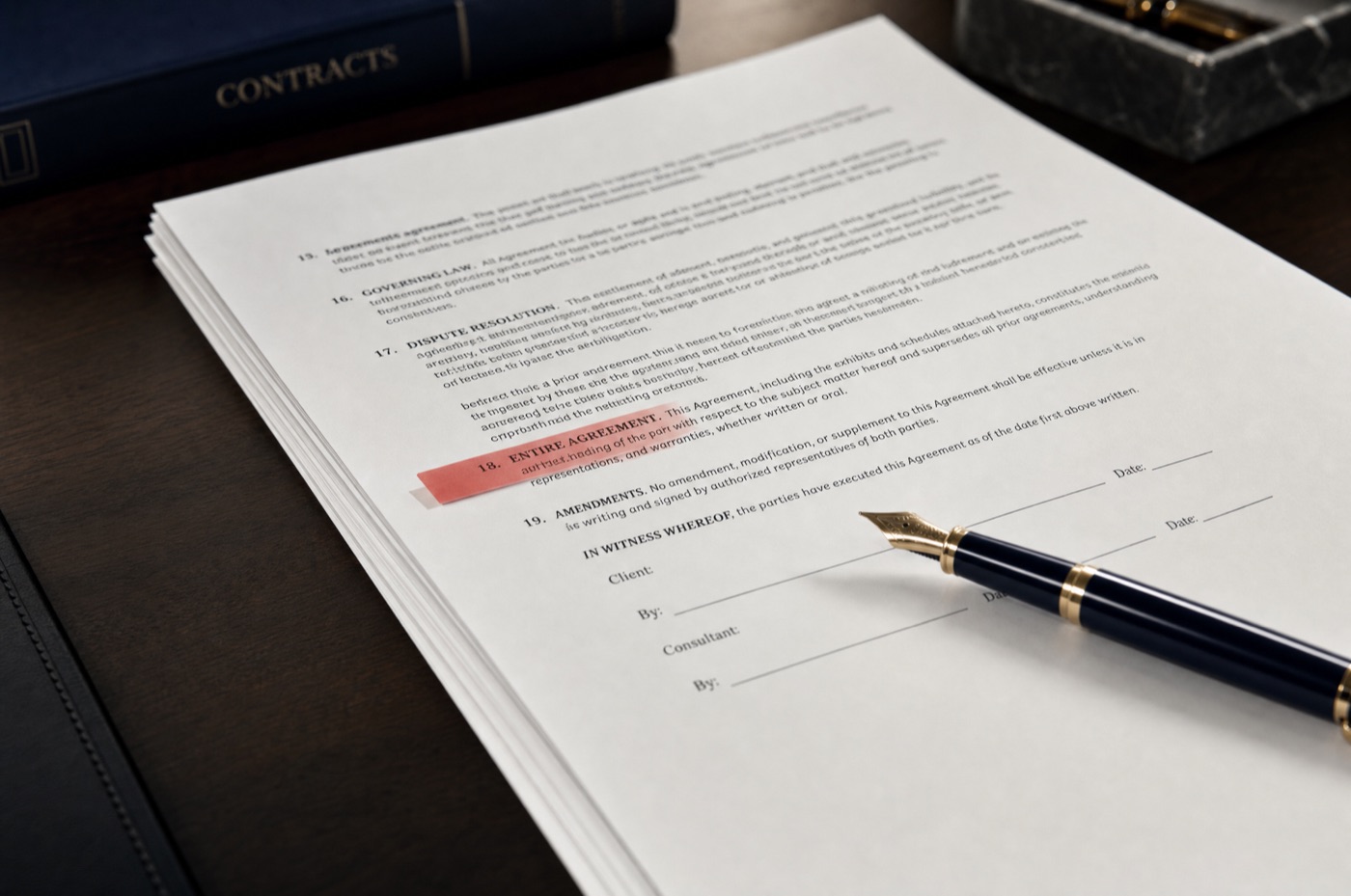 A standard form contract on a desk with one clause flagged by a red marker tab beside an unsigned signature line